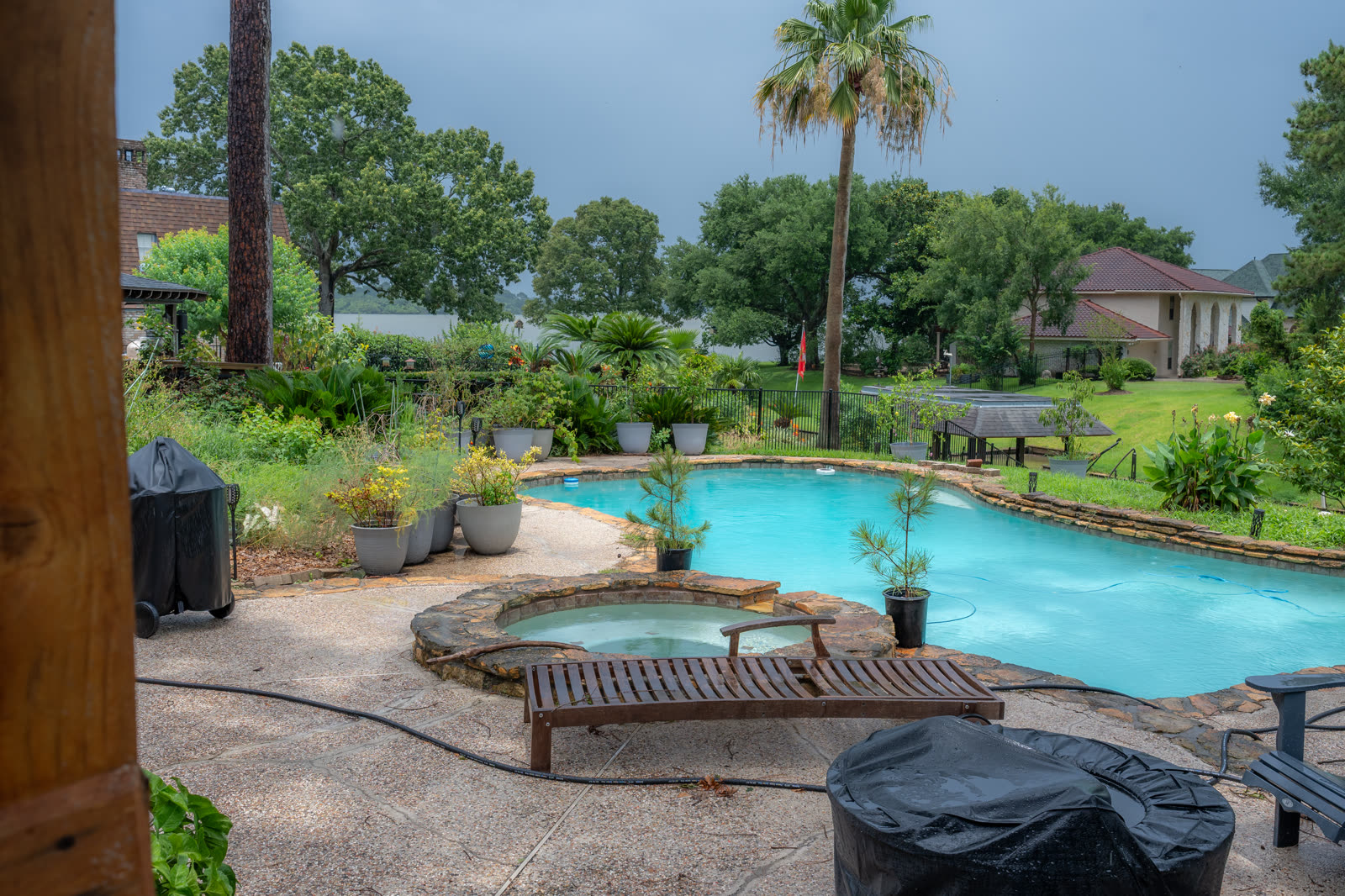 A backyard pool and lakefront property, shot by a real working photographer for a real estate listing